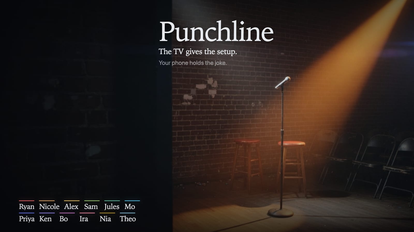 An empty comedy club stage on the television, a single amber spotlight on the microphone and two stools.