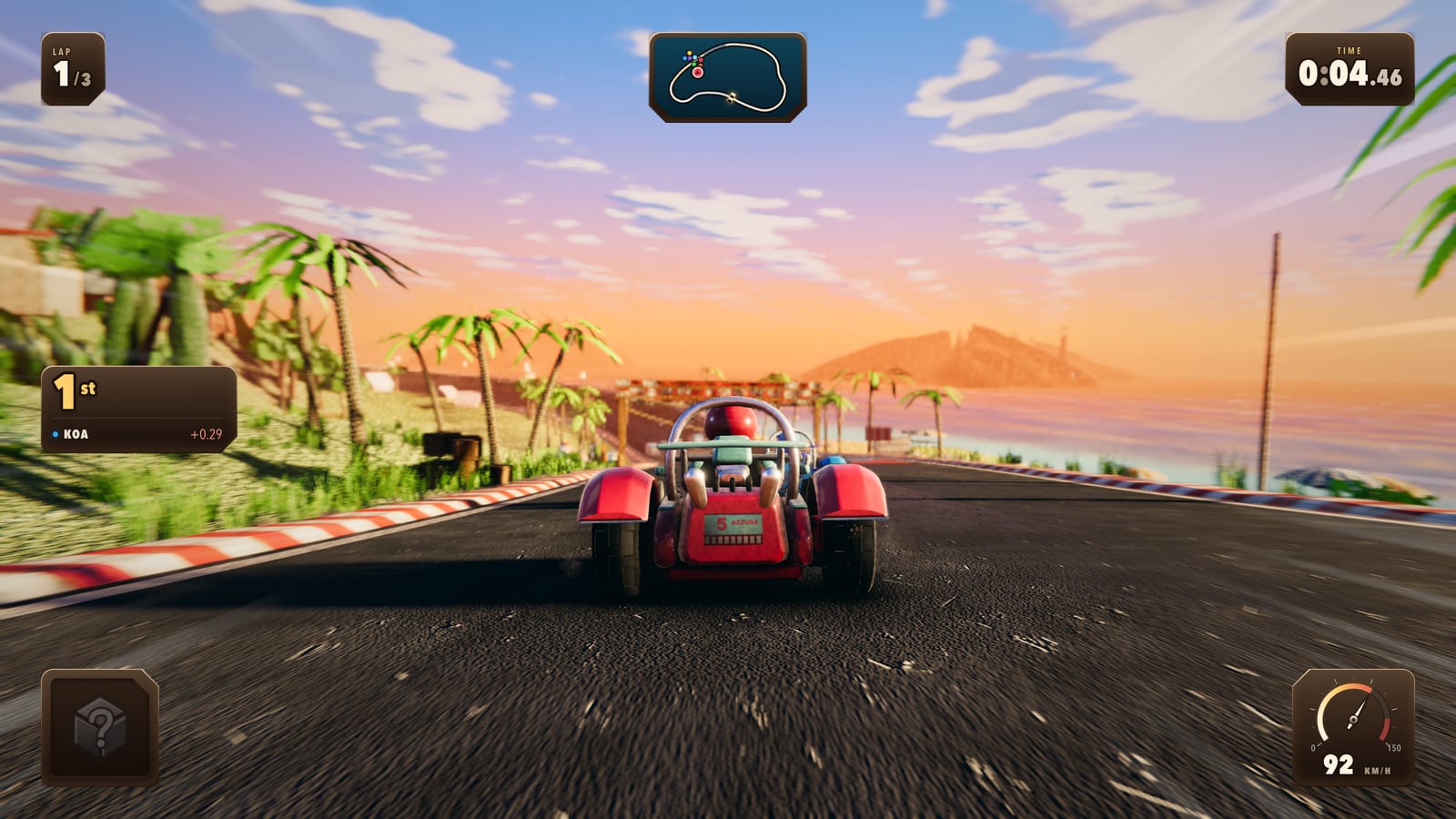 A kart on the coast road at sunset, palms along the beach on the left and the sea running out to a headland on the right.